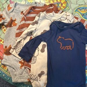 4-piece bundle of long-sleeved onesies by Carter’s; 3 mo